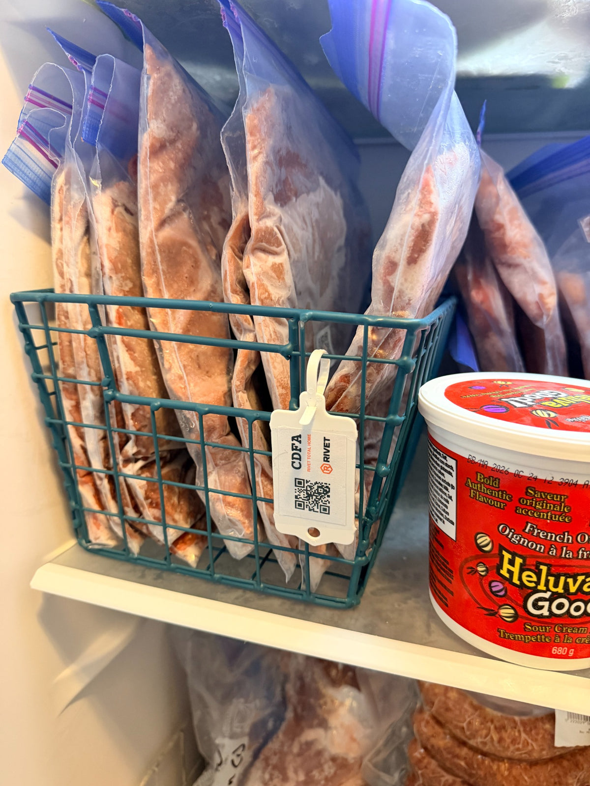 RIVET hanging tag on a freezer basket of food