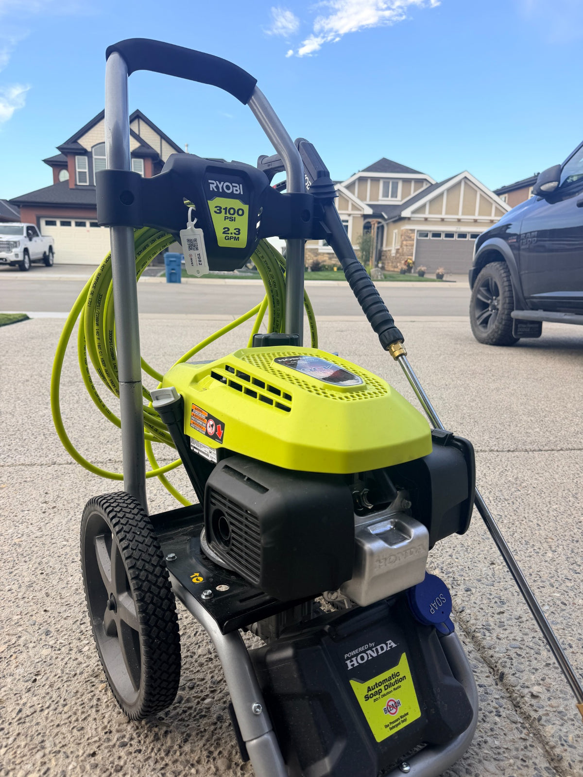 RIVET reusable hanging QR tag on a pressure washer