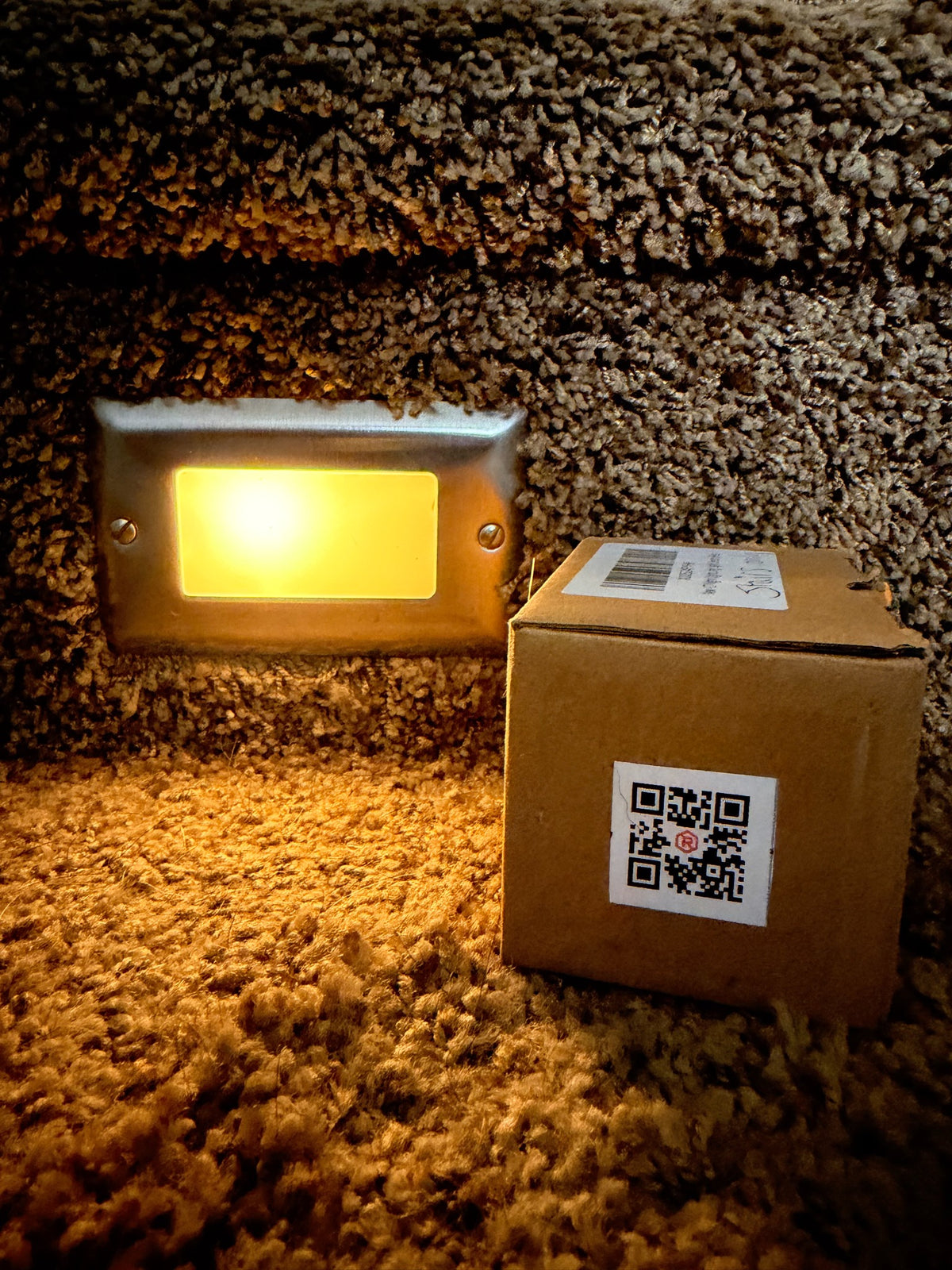 RIVET compact QR label on a box of spare outdoor lights